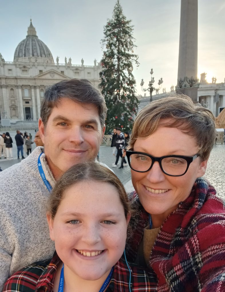 Picture of a family with the Vatican City, at Christmas, in the Background
